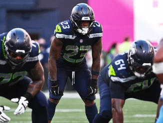 Emanuel Wilson in Seattle Seahawks uniform before a snap against the Chargers, featured in the Week 5 fantasy football waiver wire and FAAB report